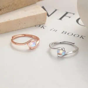 Detail of adjustable S925 silver rings with oval opal stones in rose gold and white gold