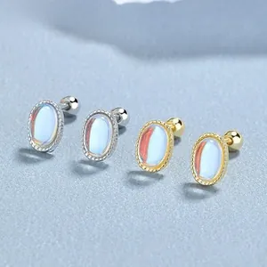 Detailed shot of oval moonstone screw back stud earrings in silver and gold finishes