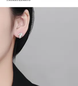 Macro shot of 925 silver cabbage thread stud earring on ear with high gloss finish