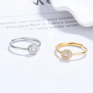Detail of square zircon geometric rings in gold and silver finish with pave setting