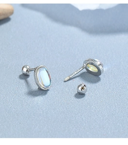 Macro detail of 925 sterling silver screw back stud earring with oval moonstone inlay
