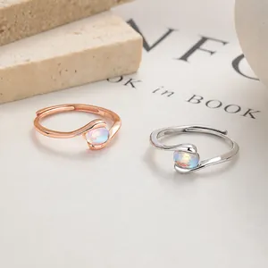 925 silver adjustable moonstone rings in rose gold and silver finish on stone background