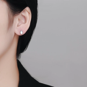 Elegant 925 sterling silver oval moonstone stud earrings worn on a female model