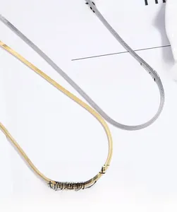 Detailed view of flat snake bone chain necklaces in gold and silver finish