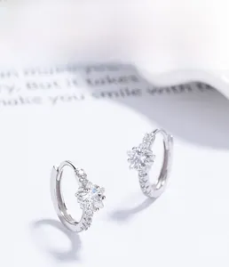 Close-up of S925 sterling silver hoop earrings with star-cut cubic zirconia and small pavé stones