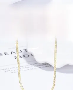 Macro shot of 18k gold plated S925 sterling silver flat snake chain texture and shine