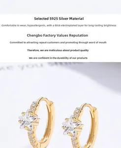 Macro shot of gold S925 silver star hoop earrings with sparkling zircon inlay details