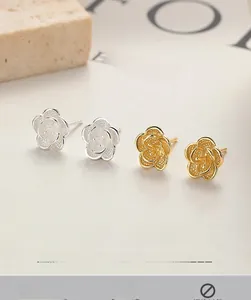 Macro detail of 925 sterling silver camellia flower studs in gold and silver finishes