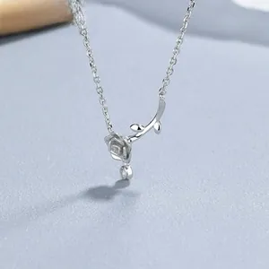 Detailed macro view of a 925 sterling silver rose pendant with fine link chain