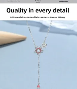 Detail of S925 sterling silver cherry blossom necklace with pink petals and pearl inlay