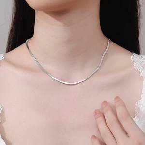Flat silver snake bone necklace for women in S925 sterling silver worn by a model