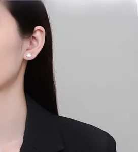 Detailed close-up of 925 sterling silver rose flower stud earring on female model