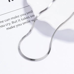 Elegant 925 sterling silver flat snake bone chain necklace displayed on a white dish