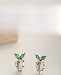 Detail of S925 sterling silver carrot stud earrings with blue moonstone and green gems