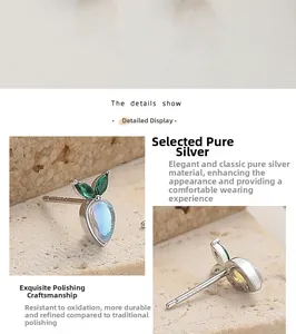 Macro shot of S925 sterling silver carrot stud earrings with moonstone and green gemstones