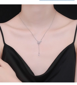 Detail of 925 sterling silver cherry blossom necklace with pink pendant on a model