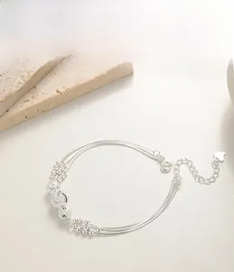 Detailed close-up of S925 sterling silver multilayer bracelet with beads and heart charm
