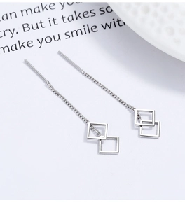 Macro shot of S925 sterling silver ear threads with hollow geometric square tassels