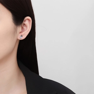 925 silver carrot stud earring with blue moonstone and green leaf detail on ear