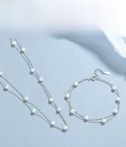 Detail of 925 sterling silver double-layer bracelet and necklace with white pearls