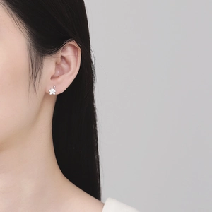 Minimalist 925 sterling silver maple leaf stud earrings on model for daily wear