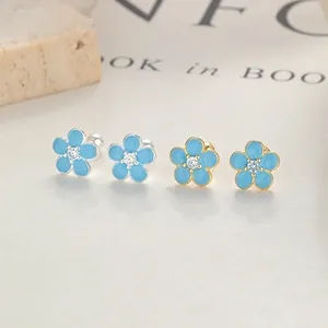 Detail of floral earrings with light blue enamel petals and sparkling cubic zirconia centers