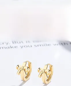 Detail view of gold S925 sterling silver bow earrings with visible hallmark stamp