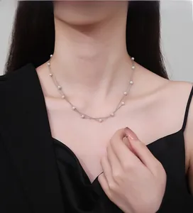 Detail view of double-layer sterling silver necklace with delicate white pearls
