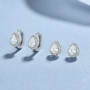 925 silver teardrop zircon earrings set with sparkly stones on a light blue background