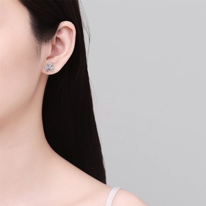 Sparkling 925 sterling silver clover stud earring with pavé crystals on female model