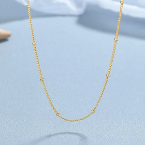 Elegant 925 sterling silver gold beaded curb chain necklace for women on blue background