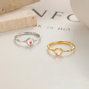 Macro detail of adjustable ring with bamboo texture and red heart gemstone inlay