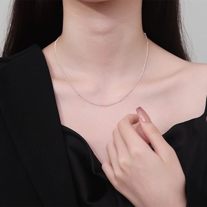 Elegant 925 sterling silver beaded choker necklace on model wearing black outfit