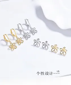 Flat lay of gold and silver hollow flower stud earrings and hoops on a white porcelain dish