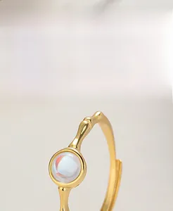 Close-up of gold-plated S925 silver ring featuring a clear iridescent moonstone gemstone