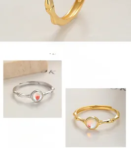 Detail view of 925 silver adjustable rings with bamboo-textured band and opal stones