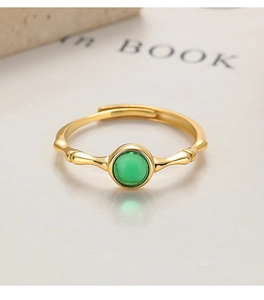 Detail of adjustable gold-plated bamboo ring with a polished green oval gemstone