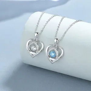 Detail of 925 sterling silver heart necklaces with blue and white zircon stones