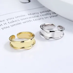 Detail of adjustable S925 sterling silver rings with irregular wave texture and hallmarks