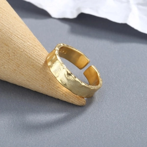 Macro detail of the S925 hallmark on an adjustable hammered texture gold-plated ring