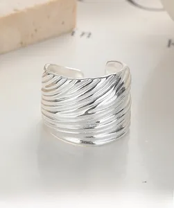Detail of 925 sterling silver striped ring showing textured surface and adjustable open band