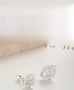 Macro shot of 999 silver rose earrings with cubic zirconia and threaded screw ball backs