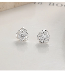 Macro shot of 999 sterling silver rose stud earrings with sparkling cubic zirconia centers