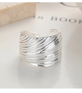 Macro detail of adjustable 925 sterling silver ring with wavy textured surface