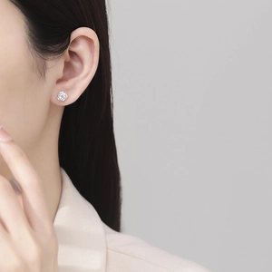 Elegant 999 sterling silver rose stud earring with a sparkling central zircon on model