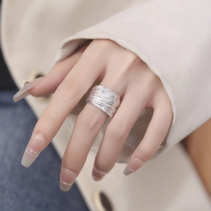 Polished 925 sterling silver wide textured open ring on a female finger