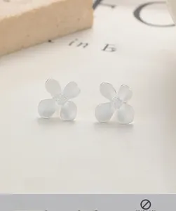 Detail view of S925 sterling silver flower stud earrings with matte textured petals