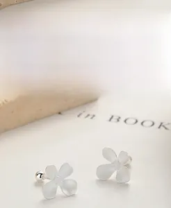 Macro detail of S925 sterling silver flower earrings with frosted matte finish