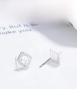 Macro detail of square halo stud earrings in S925 sterling silver with sparkling stones
