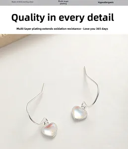 Détail de boucles d'oreilles cœur en argent 925 avec pierre de lune irisée et anti-oxydation